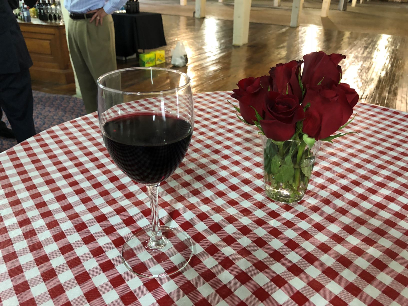 glass of wine and roses at Dottore annual networking luncheon